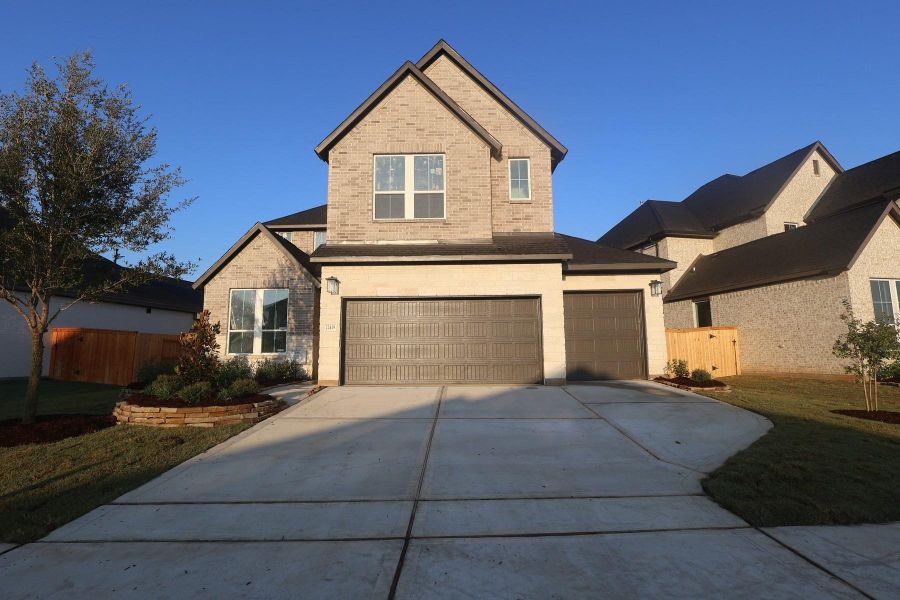 Front exterior of a new home in Oakhill Reserve, Tomball, TX, highlighting curb appeal (Image 6).
