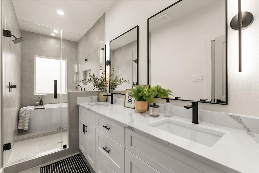 Spa-inspired primary bath with dual vanities, quartz counters, and dual mirrors Spa-inspired primary bath with dual vanities, quartz counters, and dual mirrors