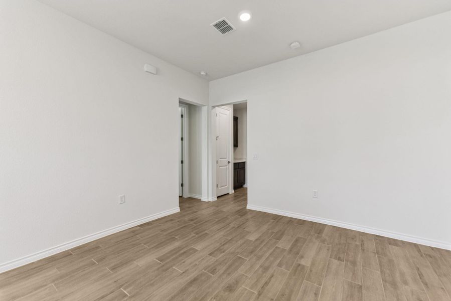 Unfurnished room with light wood-style floors and recessed lighting Unfurnished room with light wood-style floors and recessed lighting