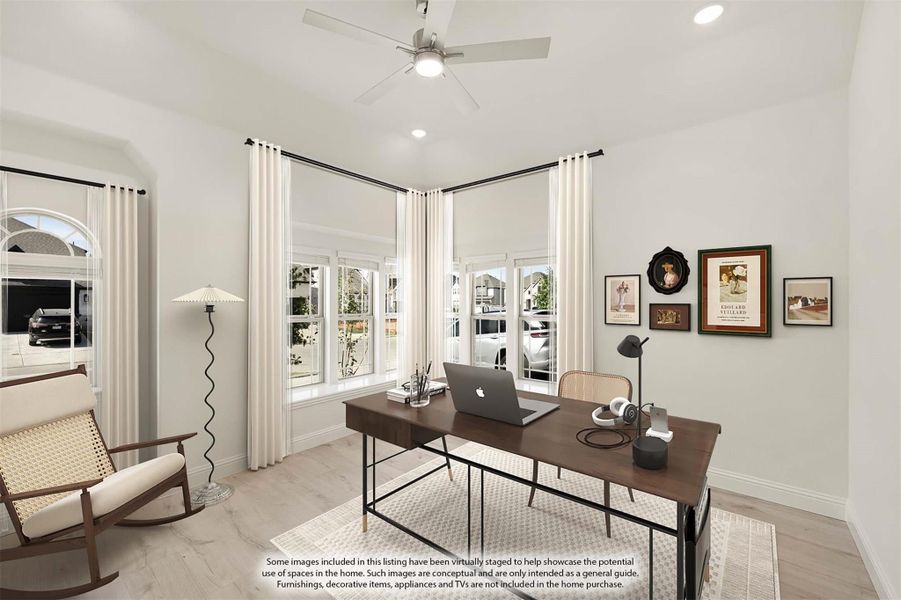 Home office with wood desk, ceiling fan, bay windows, and light hardwood floors