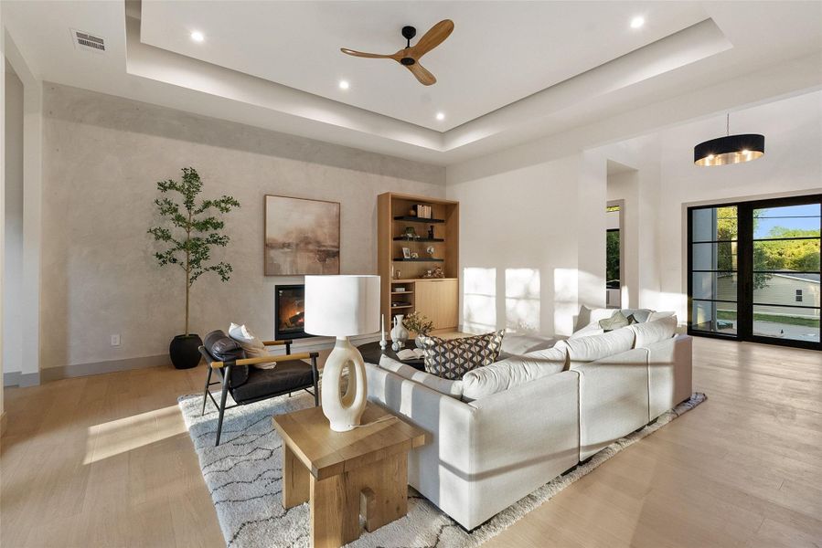 Tray ceilings raise height and give added dimension to living room space.