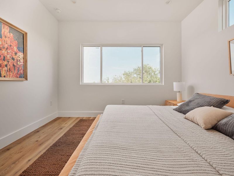 Bedroom with baseboards and wood finished floors