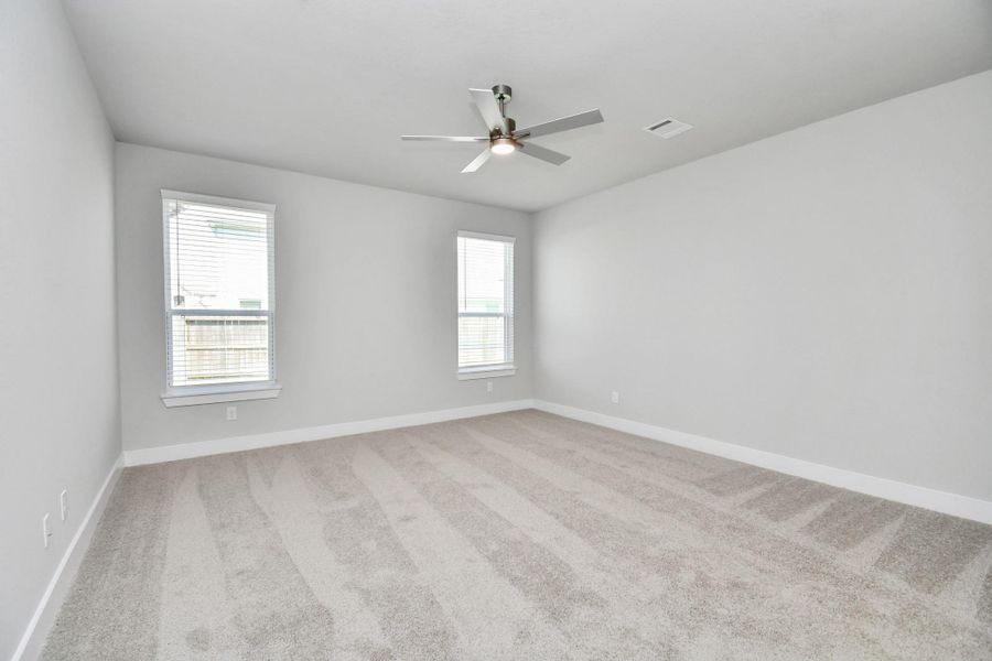 Come and unwind after a long day in this magnificent primary suite! This spacious room features plush carpet, warm paint, high ceilings and large windows with privacy blinds. Sample photo of completed home with similar floor plan. Actual colors and selections may vary. Come and unwind after a long day in this magnificent primary suite! This spacious room features plush carpet, warm paint, high ceilings and large windows with privacy blinds. Sample photo of completed home with similar floor plan. Actual colors and selections may vary.