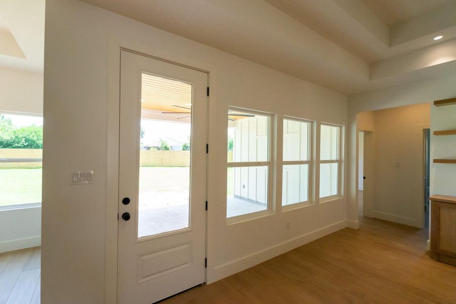 Custom 9-foot rear patio door providing abundant natural light & seamless access to the outdoor living space.
