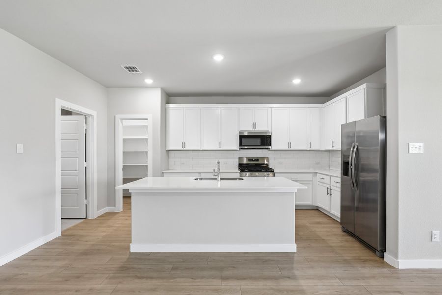 Kitchen in the Oscar home plan by Trophy Signature Homes