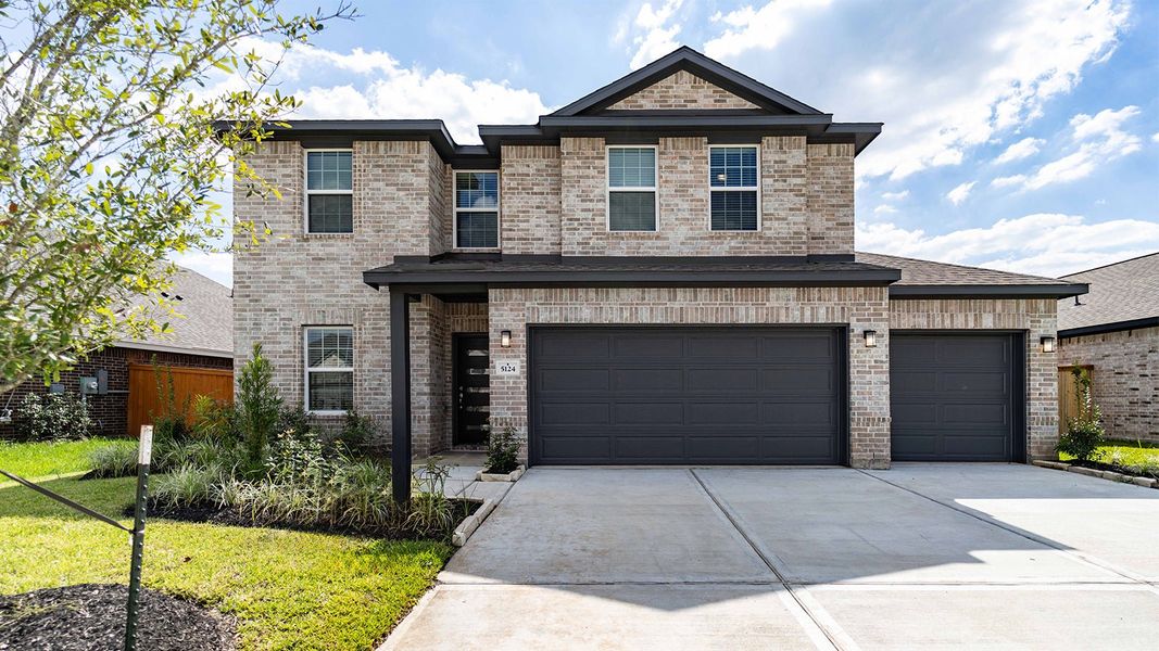 Front exterior of a new home in Massey Oaks, Pearland, TX, highlighting curb appeal (Image 1).