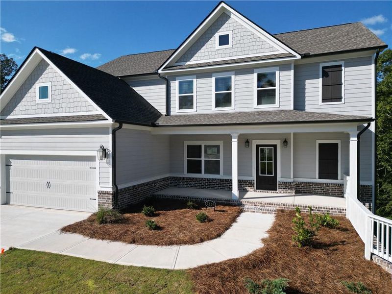 Front exterior of a new home in Woodland Hills, Loganville, GA, highlighting curb appeal (Image 2). Front exterior of a new home in Woodland Hills, Loganville, GA, highlighting curb appeal (Image 2).