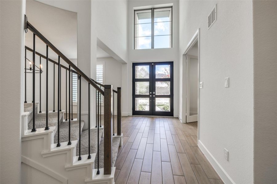 Stunning 2 story entry with double glass doors, tile floors throughout