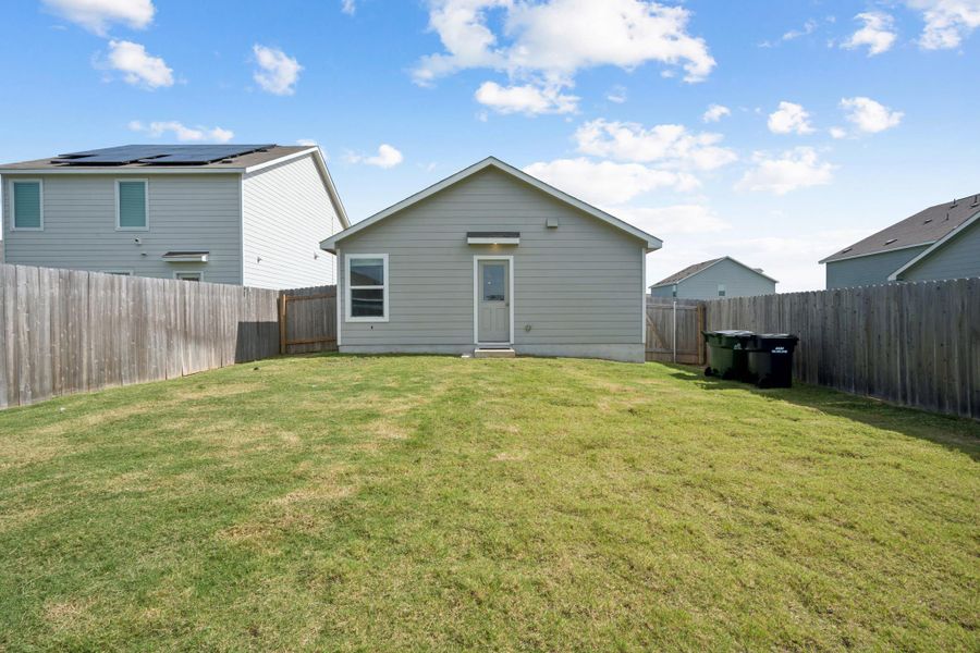 A private yard with a wooden fence and a sturdy back entrance awaits your personal touch. A private yard with a wooden fence and a sturdy back entrance awaits your personal touch.
