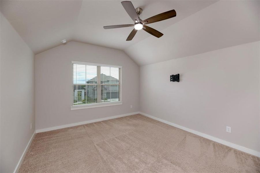 Bonus room with light colored carpet, lofted ceiling, and ceiling fan Bonus room with light colored carpet, lofted ceiling, and ceiling fan