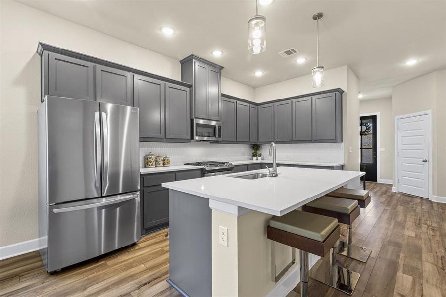 Kitchen with stainless steel appliances and wood finished floors