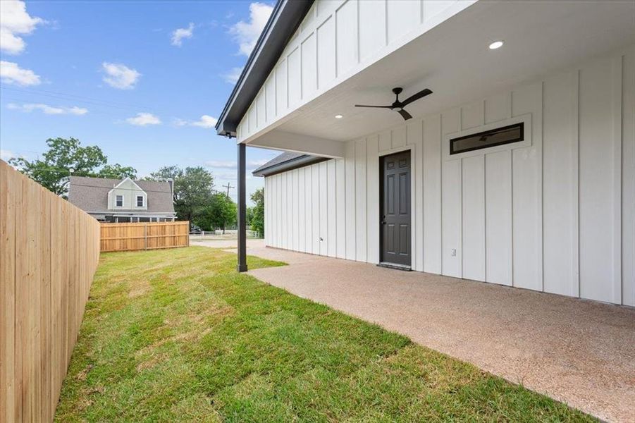 View of yard featuring a patio area and a ceiling fan View of yard featuring a patio area and a ceiling fan