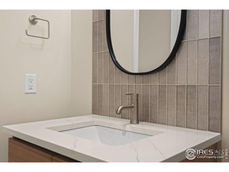 More private half-bath with a glass tile accent.