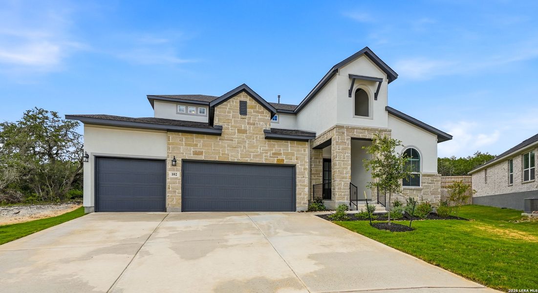 Front exterior of a new home in The Reserve at Potranco Oaks, Castroville, TX, highlighting curb appeal (Image 25).