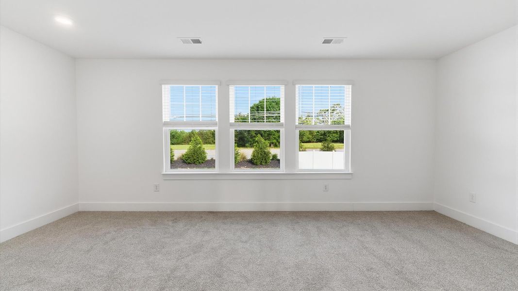 Serene and stylish primary bedroom featuring carpeted flooring and a thoughtful, modern layout at Silo Ridge