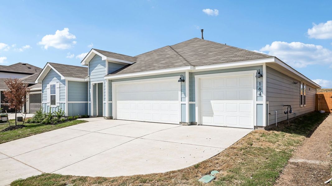 Front exterior of a new home in Prairie Lakes, Buda, TX, highlighting curb appeal (Image 22).