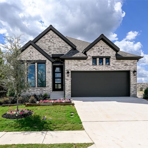 View of front of home featuring driveway, an attached garage, brick siding, a front lawn, and a shingled roof View of front of home featuring driveway, an attached garage, brick siding, a front lawn, and a shingled roof