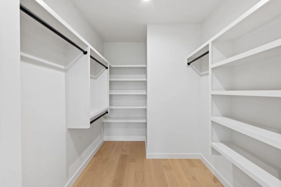 Ample shelving and hanging space defines this well-appointed walk-in closet. Ample shelving and hanging space defines this well-appointed walk-in closet.