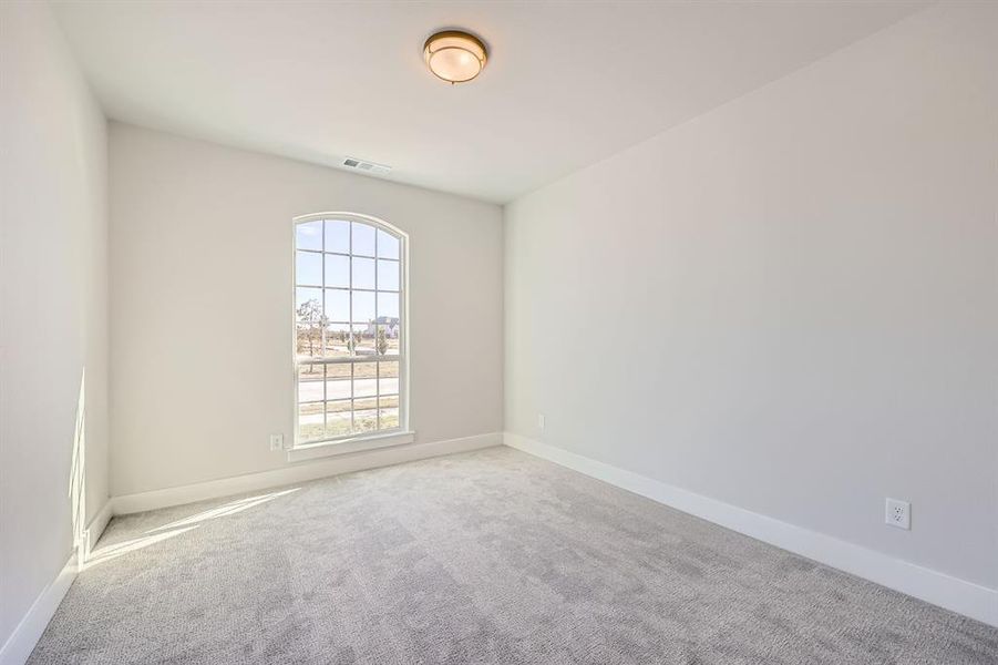 Spare room featuring light colored carpet