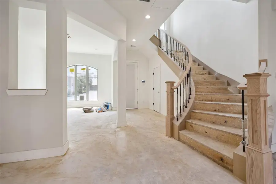 Step into a welcoming and cheerful foyer that perfectly blends function and style. The open entryway is immediately flanked by a sun-drenched dining room, making it easy to imagine hosting holiday gatherings. Just opposite, a graceful staircase, sweeps upward, creating an impressive first impression and an open, airy atmosphere that carries throughout the home.