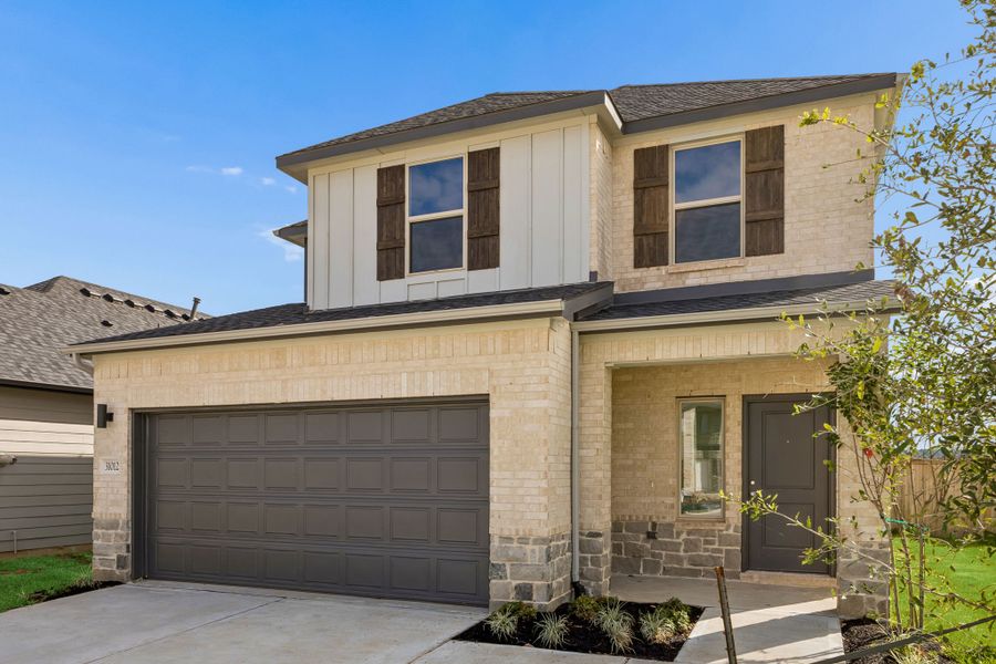 Front exterior of a new home in Riviera Pines, Huffman, TX, highlighting curb appeal (Image 20). Front exterior of a new home in Riviera Pines, Huffman, TX, highlighting curb appeal (Image 20).