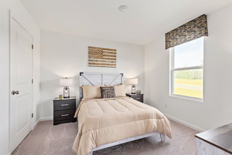 A bedroom with a bed and a window.