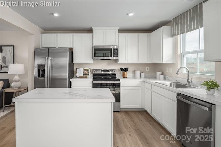 Enjoy the clean lines and generous storage of 36-inch cabinetry in this beautifully appointed kitchen