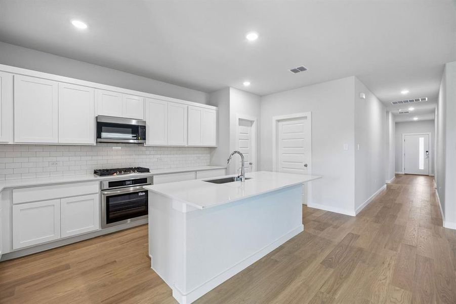 Kitchen in the Oscar home plan by Trophy Signature Homes – REPRESENTATIVE PHOTO