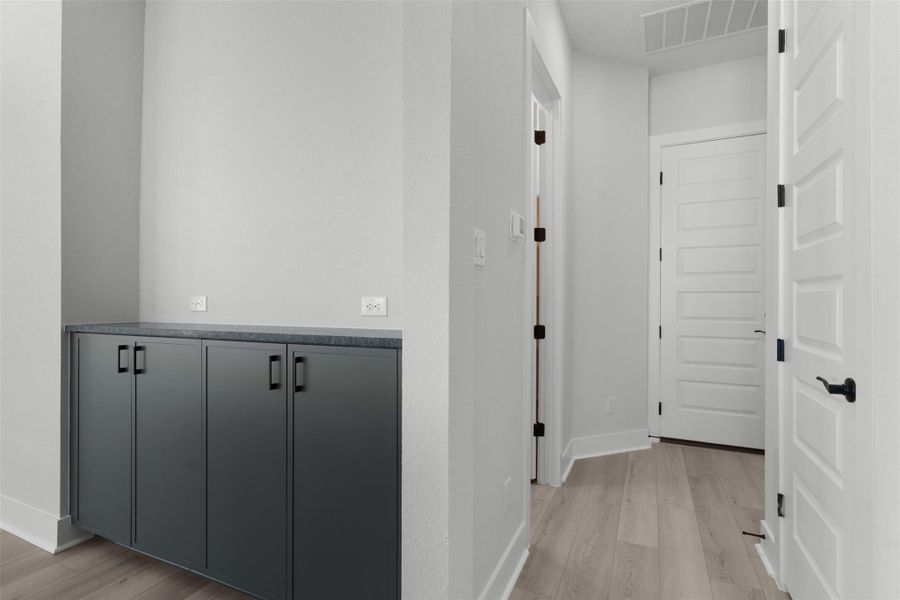 Hall with light wood finished floors