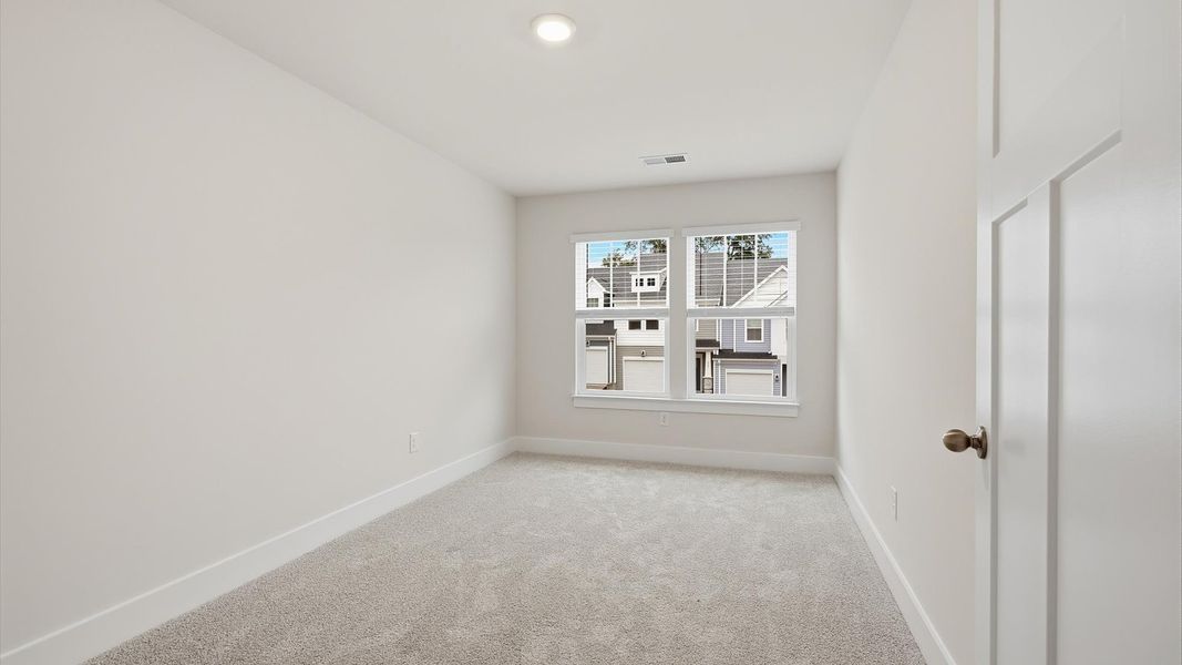 Vibrant and inviting secondary bedroom featuring a walk-in closet and refined finishes by DRB Homes