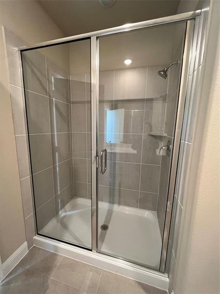 Bathroom featuring a stall shower and tile patterned floors