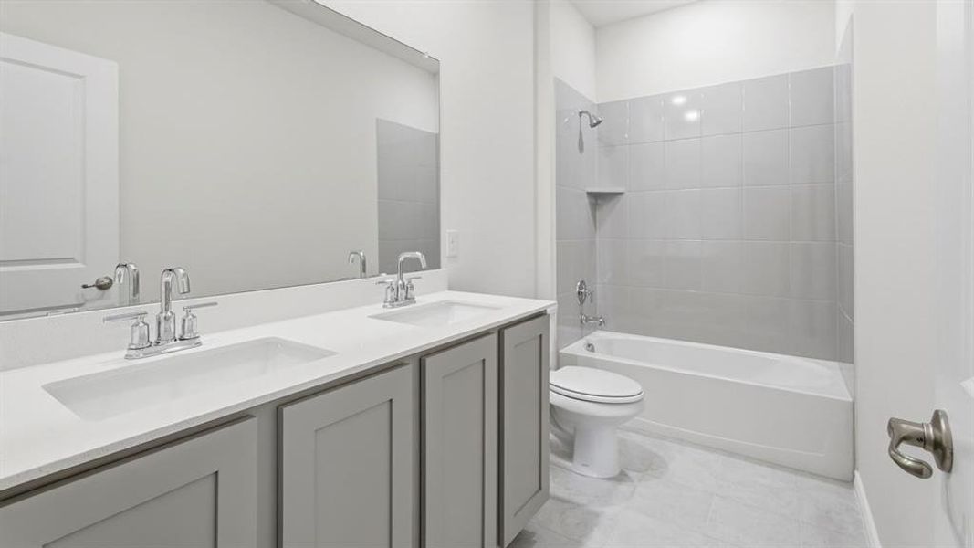 Bathroom with bathtub / shower combination and double vanity