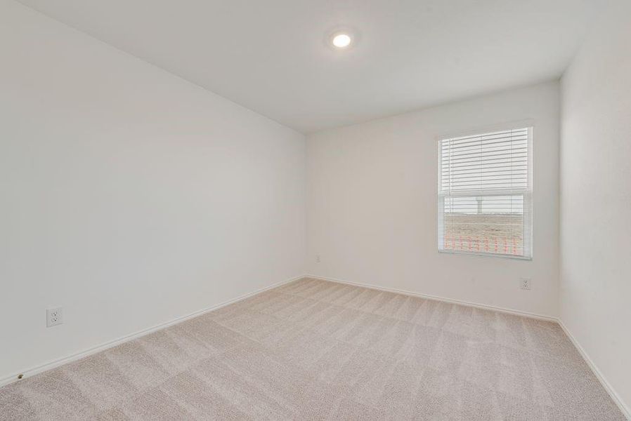 Empty room with baseboards and light colored carpet