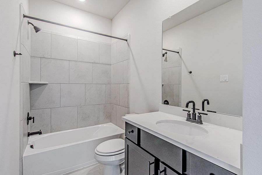 Secondary bathroom with vanity and tub/shower combination Secondary bathroom with vanity and tub/shower combination