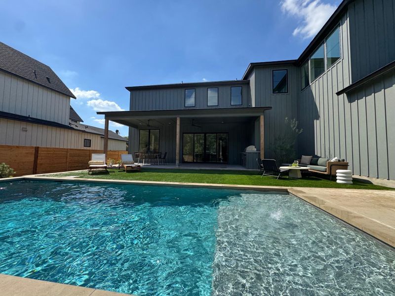 Rear view of house with a patio, a ceiling fan, outdoor lounge area, and board and batten siding Rear view of house with a patio, a ceiling fan, outdoor lounge area, and board and batten siding
