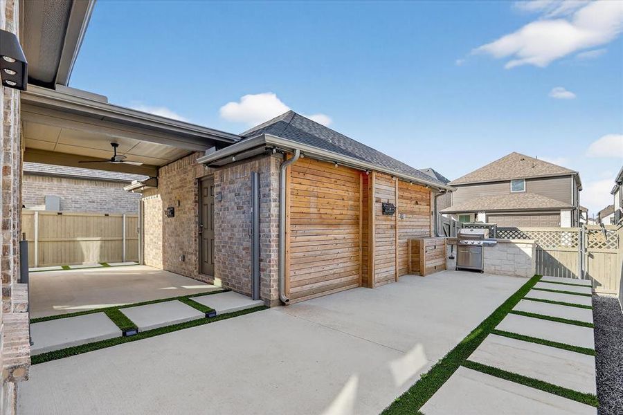 Backyard patio showing the covered walkthrough to detached garage