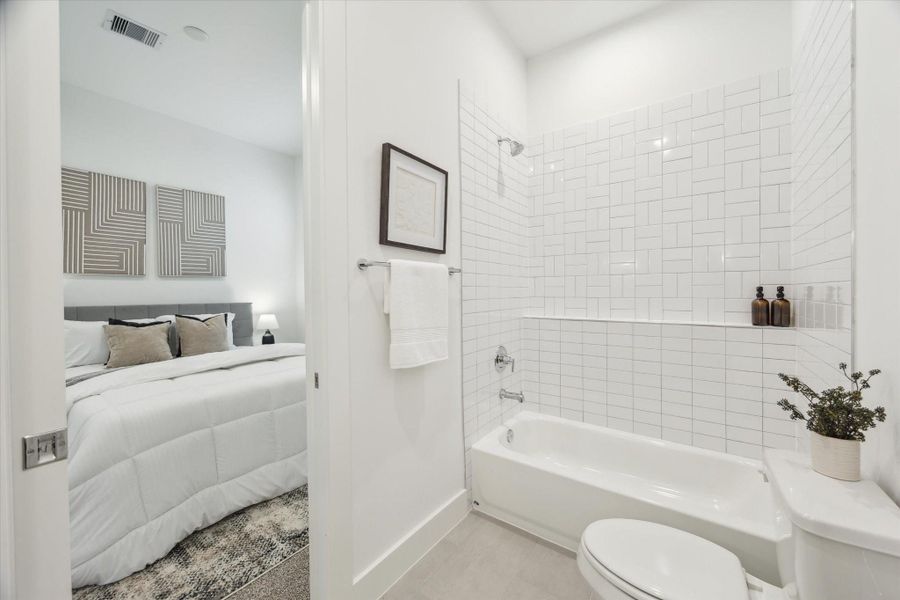 Another view of the downstairs full bath with clean lines andshower/tub tile surround