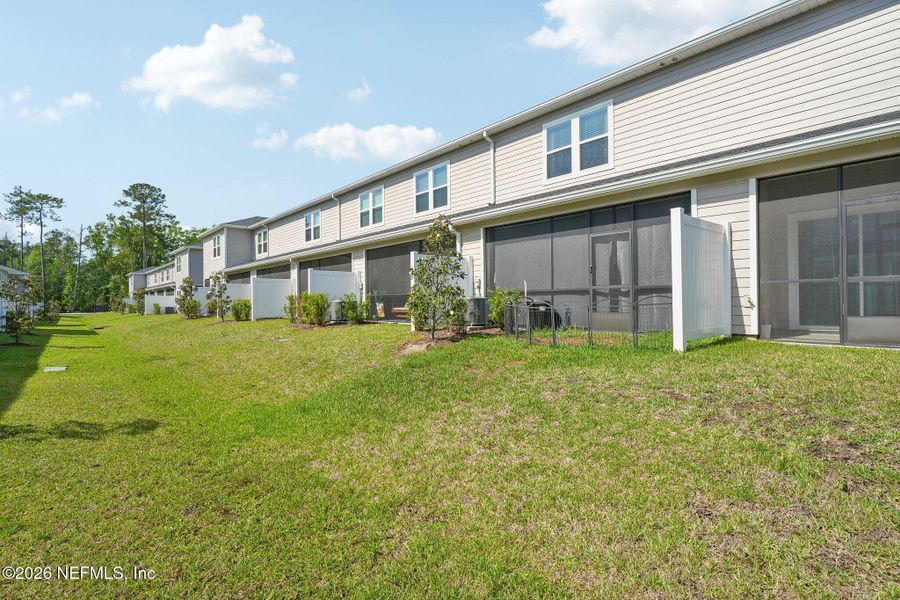 Exterior details and patio area of a home in Longbay Townhomes, Middleburg (Image 26).