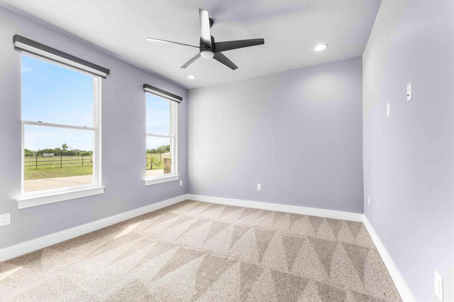 Unfurnished room with light colored carpet, ceiling fan, and recessed lighting Unfurnished room with light colored carpet, ceiling fan, and recessed lighting