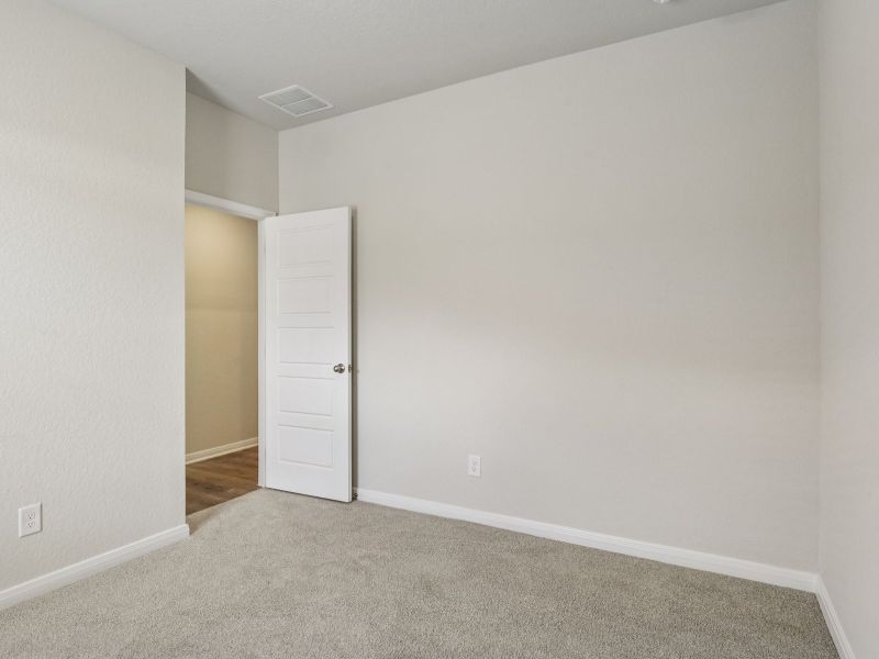 Guest bedroom in the Oleander floorplan at a Meritage Homes community.