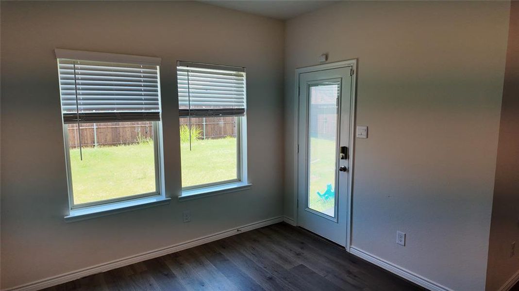 Entryway with dark wood finished floors and baseboards