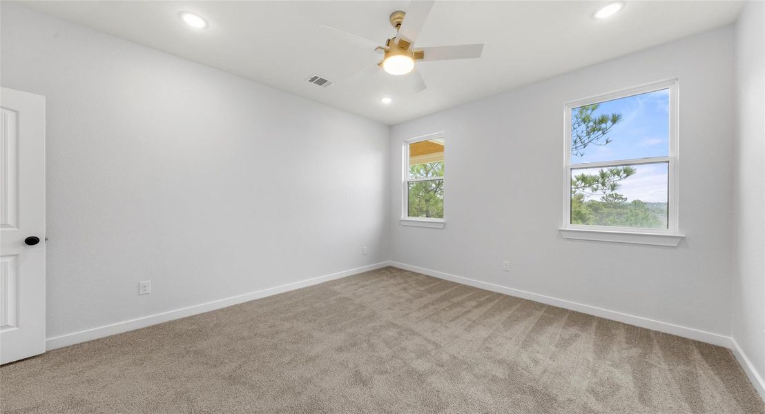 Unfurnished room featuring light carpet, a ceiling fan, and recessed lighting