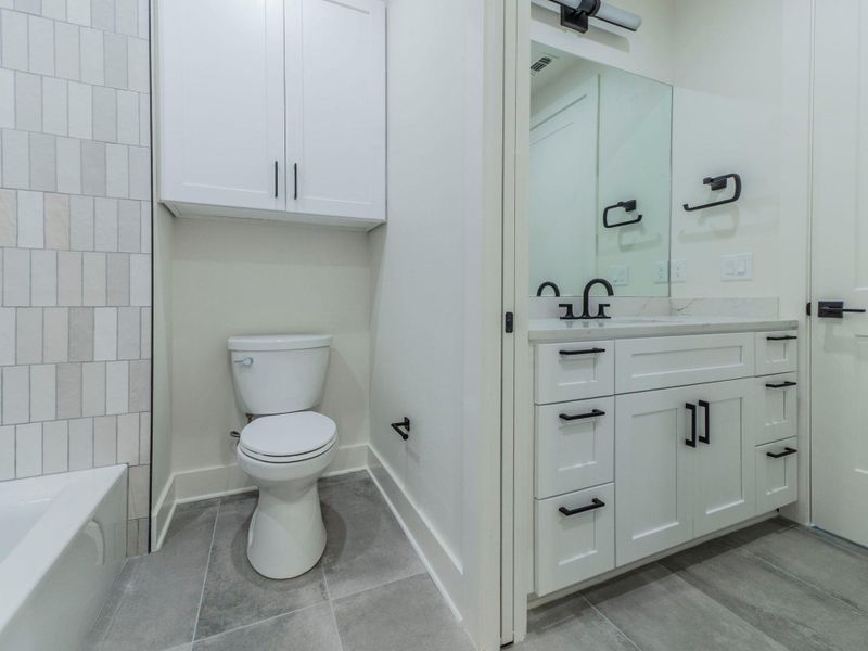Full bath featuring vanity, light tile patterned floors, and bathtub / shower combination Full bath featuring vanity, light tile patterned floors, and bathtub / shower combination