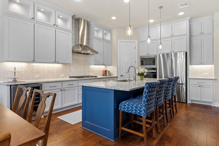 The chef-inspired kitchen features ceiling-height cabinetry and extensive counter space. The chef-inspired kitchen features ceiling-height cabinetry and extensive counter space.