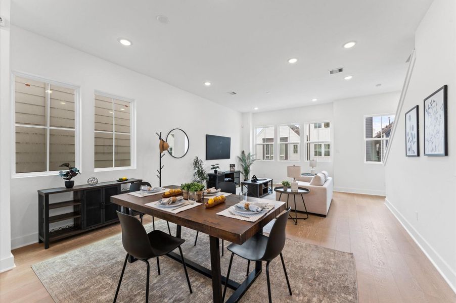 Designed for modern living, this open-concept space seamlessly unites the kitchen, dining, and living areas into one harmonious hub.