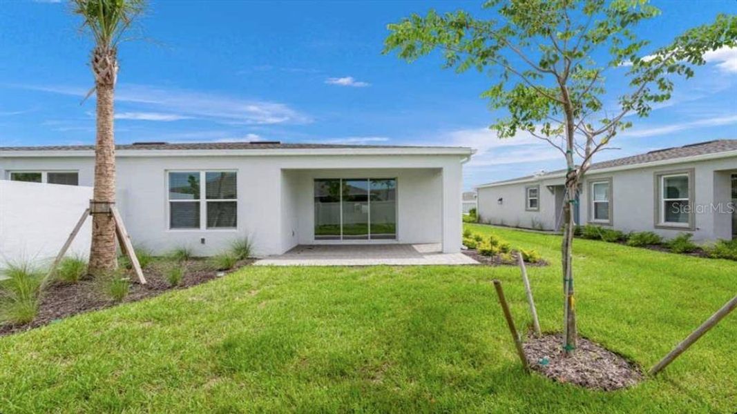 Exterior details and patio area of a home in The Cove at West Port, Port Charlotte (Image 2).