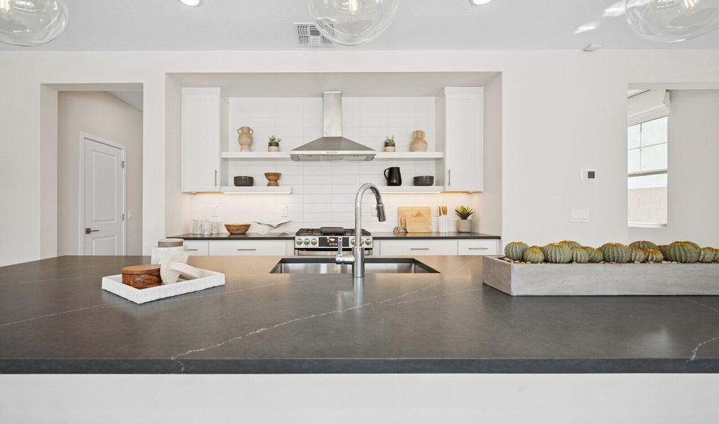 Kitchen with chrome faucet and quartz countertop