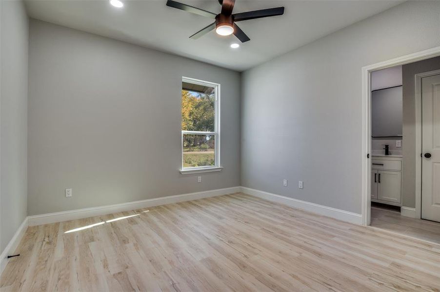 Empty room featuring light wood-style flooring, ceiling fan, and recessed lighting Empty room featuring light wood-style flooring, ceiling fan, and recessed lighting