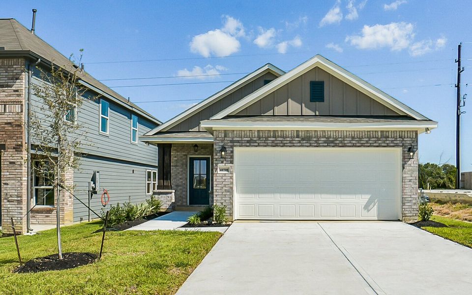Front exterior of a new home in Mostyn Springs, Magnolia, TX, highlighting curb appeal (Image 27).