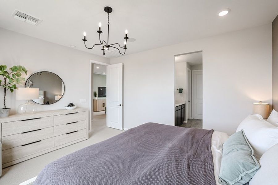 A bedroom with a bed and a mirror. A bedroom with a bed and a mirror.